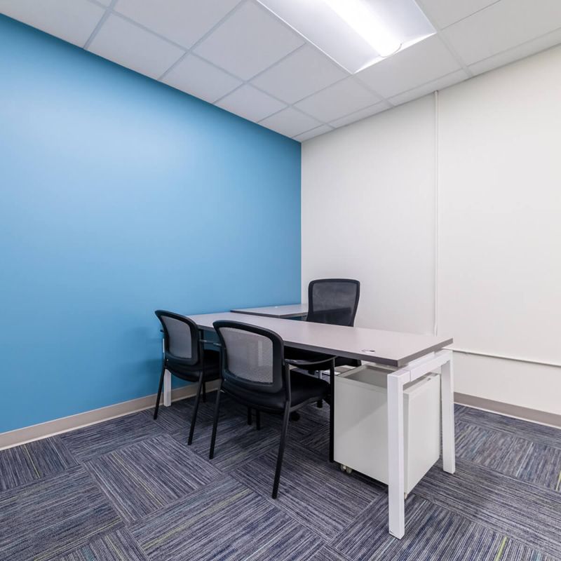 Empty Desk and Chairs with Blue wall from Urban Office in Austin, TX