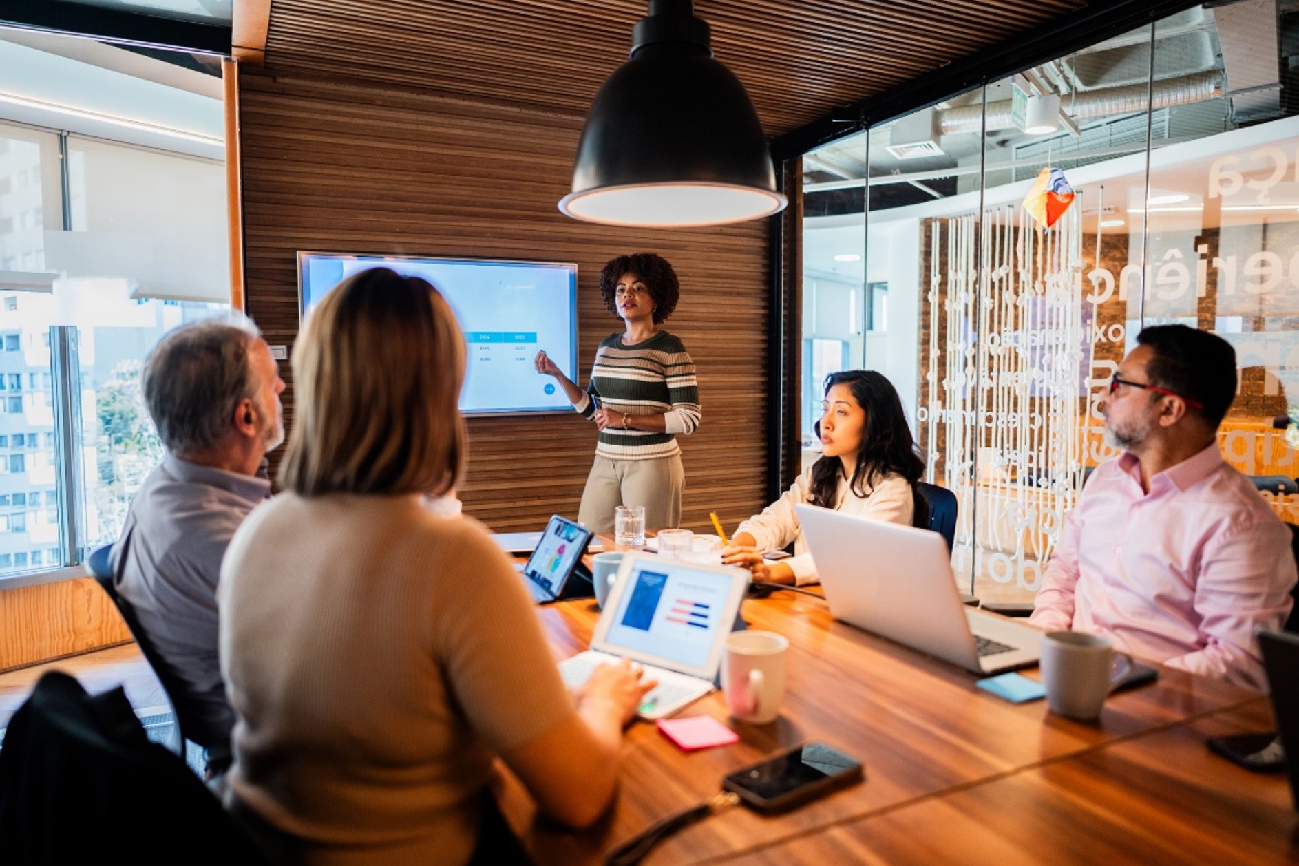 Professionals collaborating in a private meeting room at a coworking space