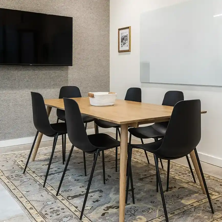 A Modern Conference Room Featuring a Large Table Surrounded by Chairs in Houston, TX