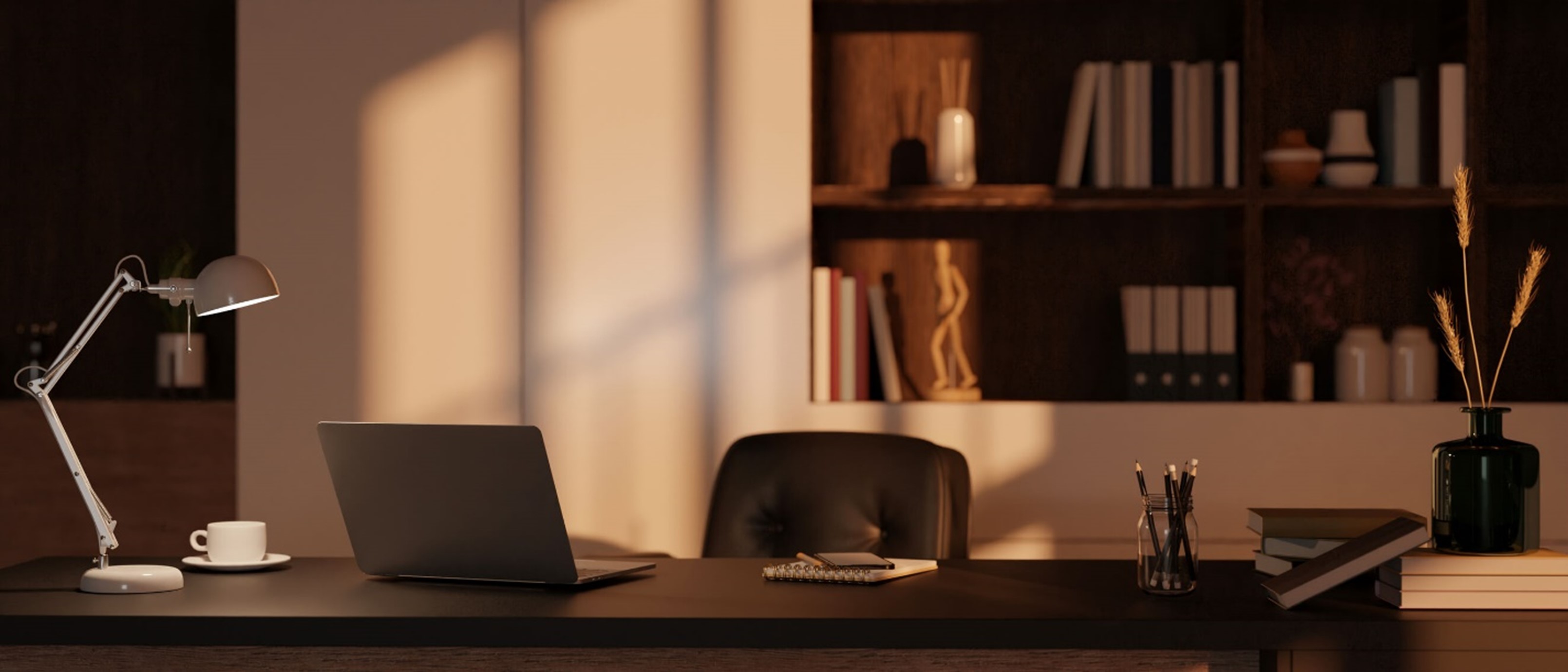 Modern home office desk with laptop, task lamp, books, and warm natural light in a minimalist workspace