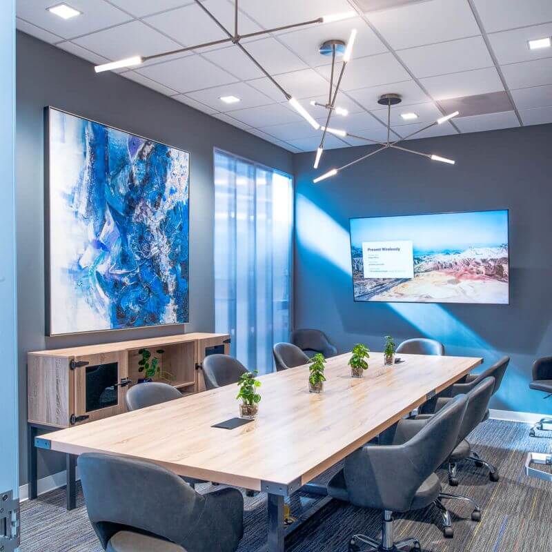 A boardroom with a TV showcasing private office space in Spring Branch Village, Houston, TX