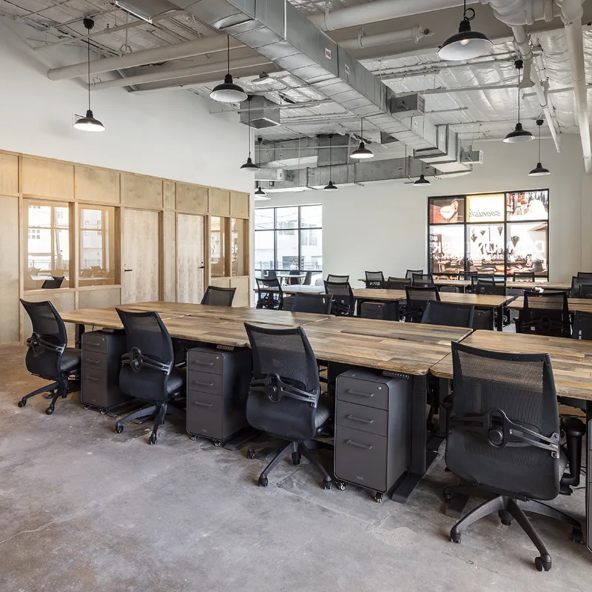 Urban office space with long tables and multiple chairs in Houston, TX