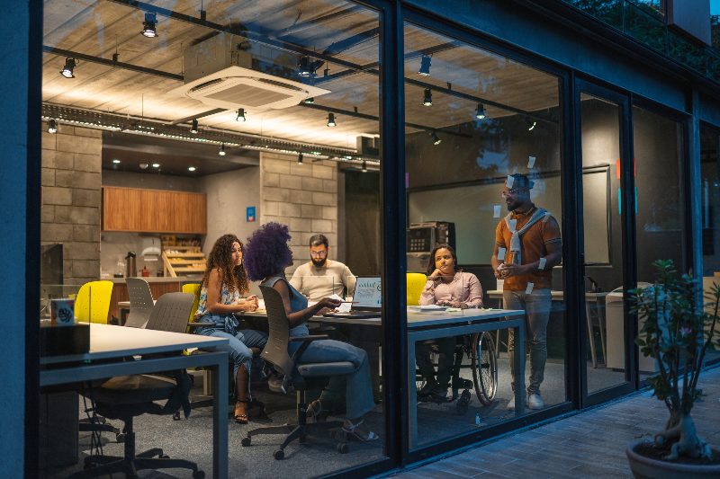 Office Environment Showcasing Employees at Desks with Glass Enclosures in Houston