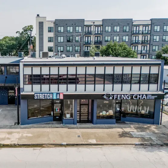 Exterior of open office facility showing exercise space and tea shop in Houston, Texas