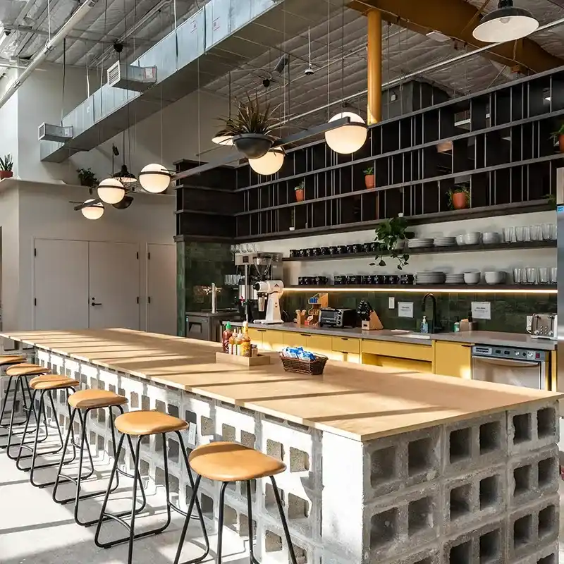 Sleek kitchen in Houston, TX, showcasing a long counter with stools, perfect for dining