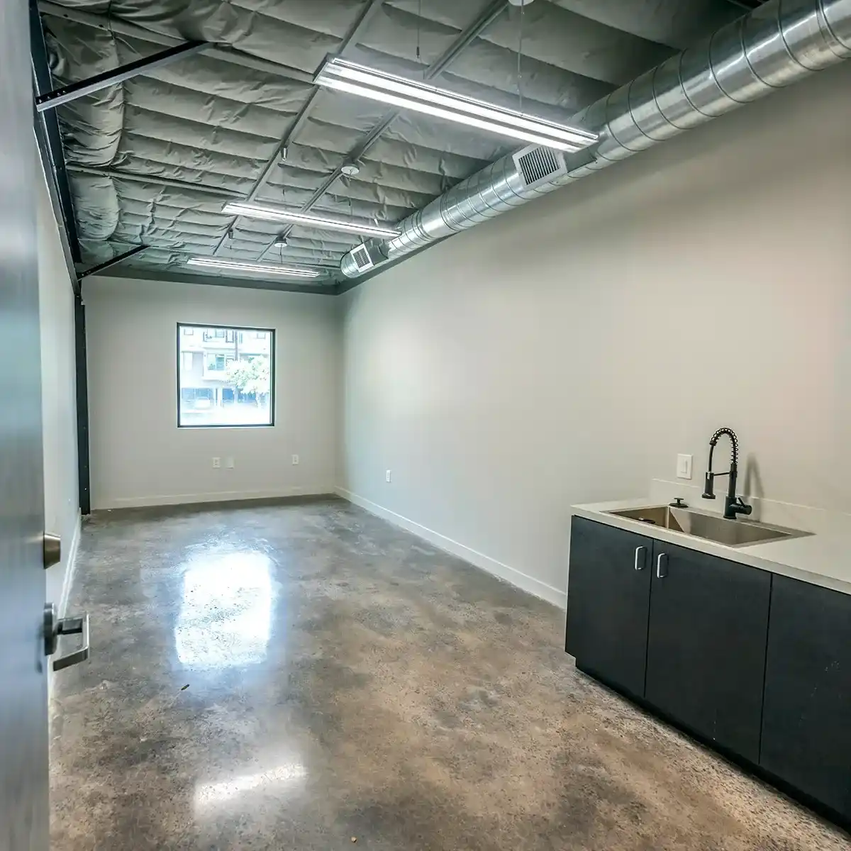 A Spacious Office Featuring a Sink and a Large Window, Providing Natural Light in Houston, TX