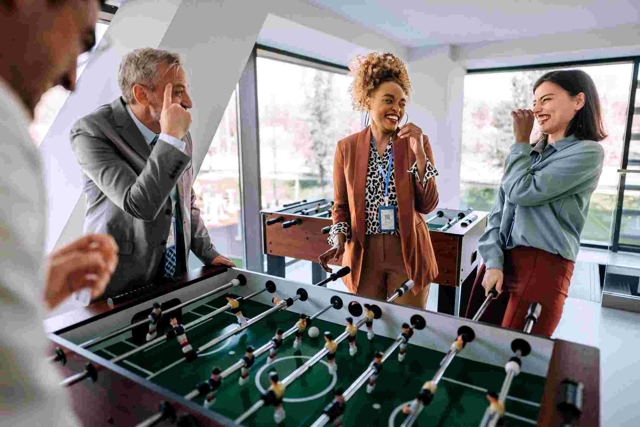 Office workers engaged in a foosball match during a break in San Antonio, TX