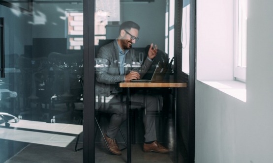 A Man at Office Inside a Room Highlighting Office Phone Booths in Houston, TX