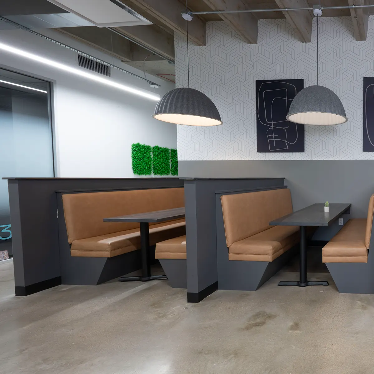 Modern office in Houston, TX featuring benches and tables for collaborative workspaces