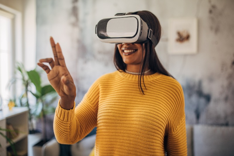 A woman using a VR headset in an office by Urban Office