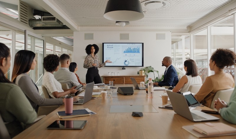 A diverse group of people sitting together at a conference table for a meeting in Houston, TX