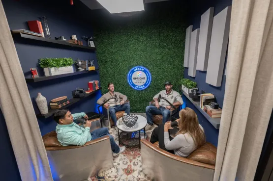 Four people podcasting in a coworking space in Texas