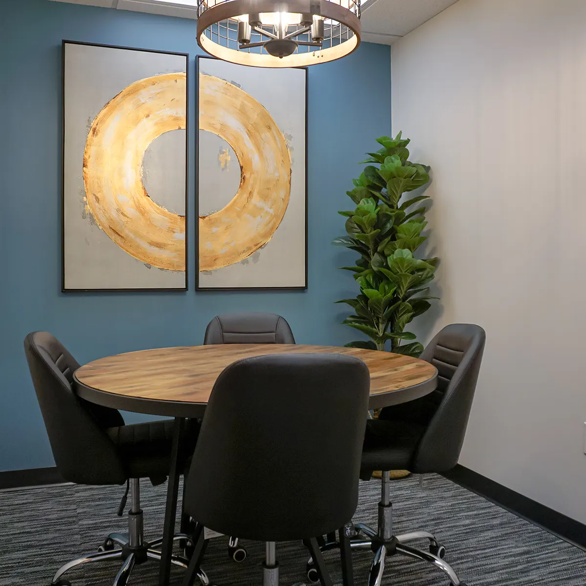 Small office space with table and four chairs and plant in the background in Medical Center, San Antonio, Texas