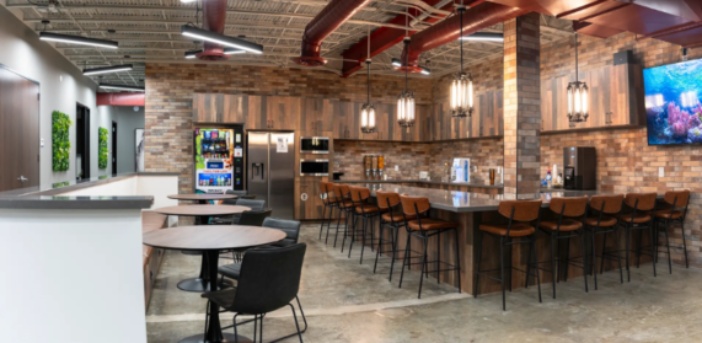 Panoramic view of a modern kitchen, set against a stylish brick wall at West Heights in Houston, TX