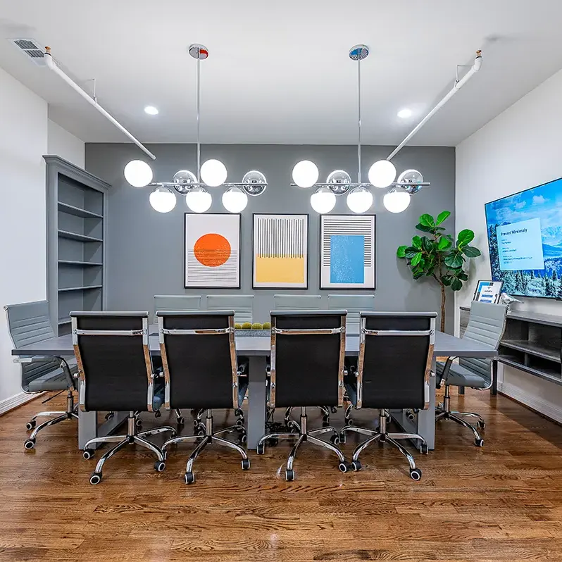 Conference room equipped with a large screen television and seating for participants in Houston, TX