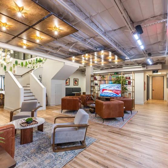 Large staircase and TV in the office lobby located in Houston, TX
