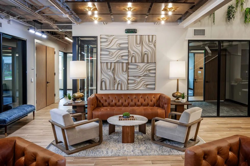 Urban Office lobby features leather couches for a welcoming coworking space in Texas