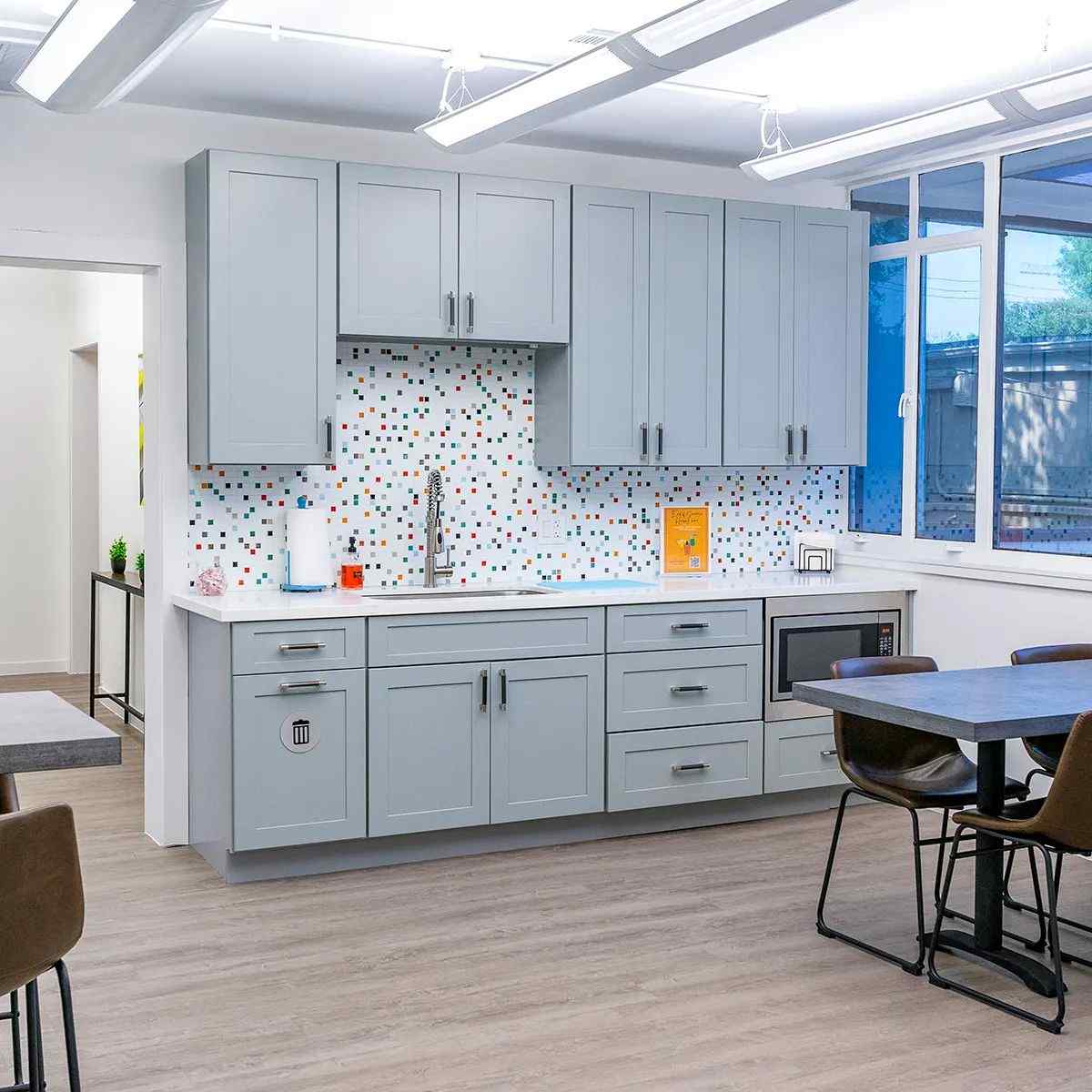 A wooden cabinet with comfortable seating in the Museum District Office in Houston, TX